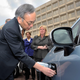 Chu inspects the charging port on a Chevy Volt.